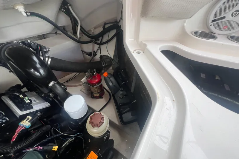 Slide: The Image of Engine compartment of a 2006 Chaparral 256 SSi boat, showing various components and wiring. - 36