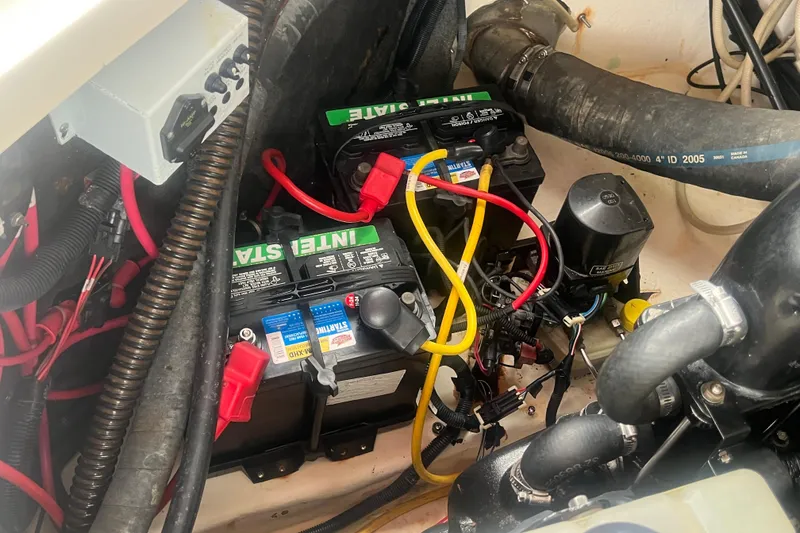 Slide: The Image of Engine compartment of a 2006 Chaparral 256 SSi boat showing batteries and wiring. - 37