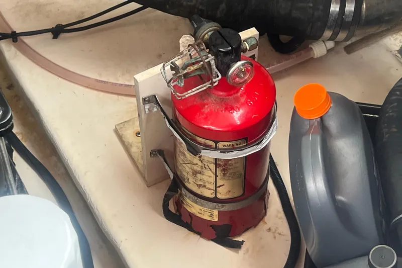 Slide: The Image of Fire extinguisher and oil container in 2006 Chaparral 256 SSi boat engine compartment. - 38