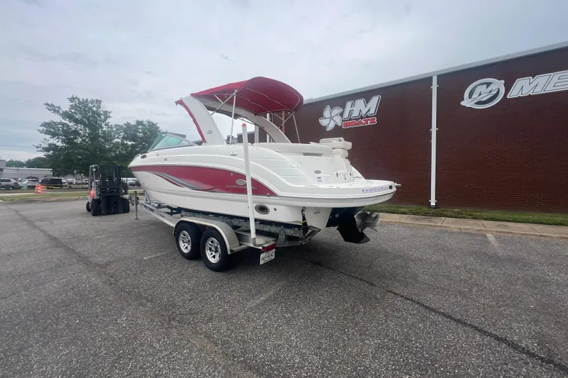 Slide: The Image of 2006 Chaparral 256 SSi boat on trailer, parked outside HM Boats dealership. - 4