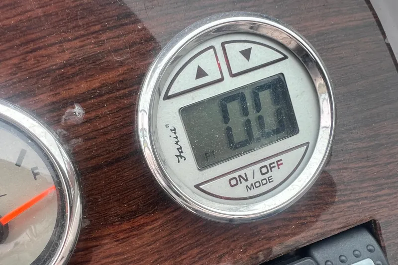 Slide: The Image of Digital gauge on 2006 Chaparral 256 SSi dashboard, displaying zero with wood paneling. - 41