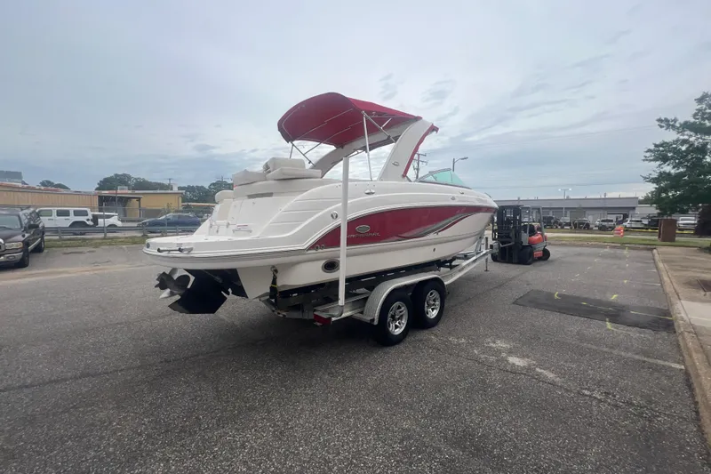 Slide: The Image of 2006 Chaparral 256 SSi boat on trailer with red canopy in parking lot. - 7
