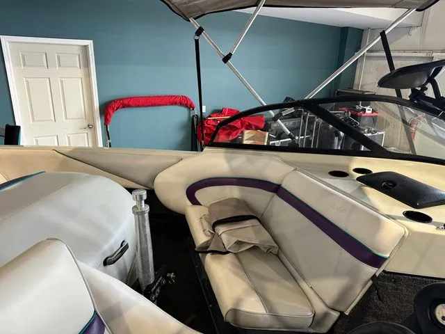 Slide: The Image of Interior of a 1995 Tigé 2002 FSLM Comp boat in a garage. - 8
