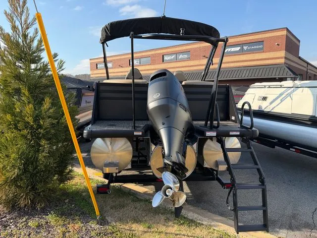 Slide: The Image of Viaggio x22u 2026 pontoon boat with outboard motor, parked in front of a building. - 7
