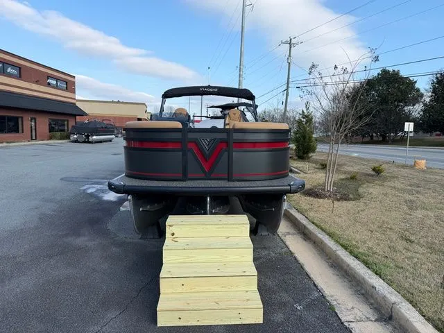 Slide: The Image of Viaggio x22u 2026 pontoon boat with wooden steps on parking lot. - 3