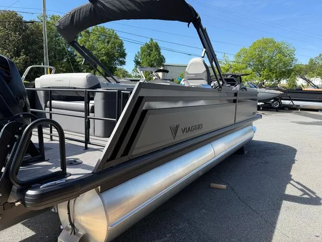 Slide: The Image of Viaggio Lago Z22B 2026 pontoon boat parked under sunny skies. - 16