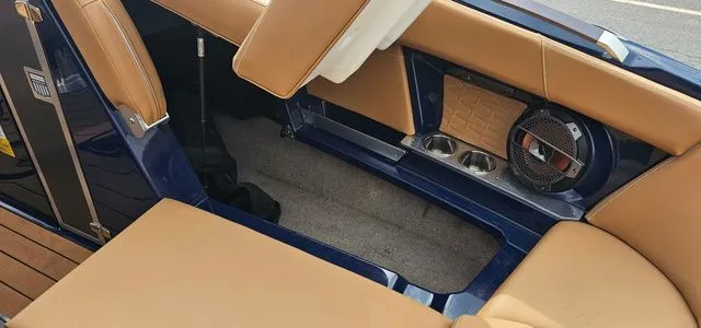 Slide: The Image of Interior of a 2020 MasterCraft X24 with brown seats and speaker. - 14