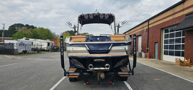 Slide: The Image of Rear view of a 2020 MasterCraft X24 boat in a parking lot. - 4