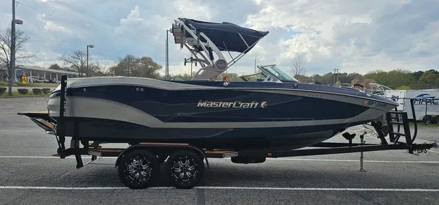 Slide: The Image of 2020 MasterCraft X24 boat on trailer, side view. - 6