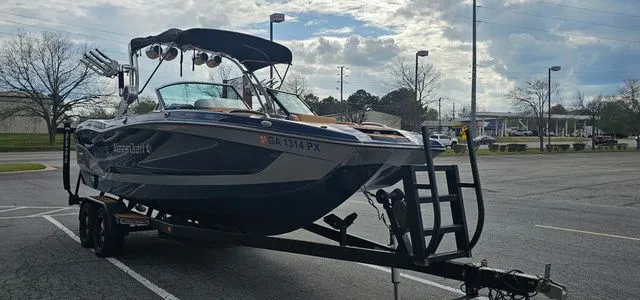 Slide: The Image of 2020 MasterCraft X24 boat parked on trailer outdoors. - 7