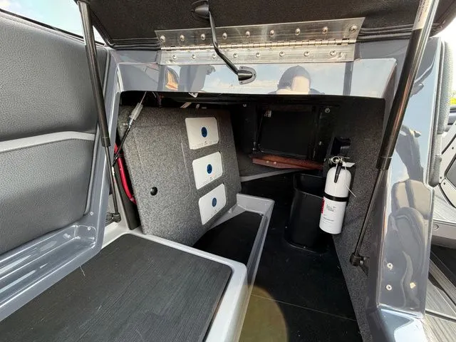 Slide: The Image of Interior of 2023 Supra SL550 with fire extinguisher and storage space. - 15