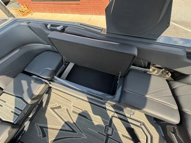 Slide: The Image of 2023 Supra SL550 interior with open storage compartment. - 16