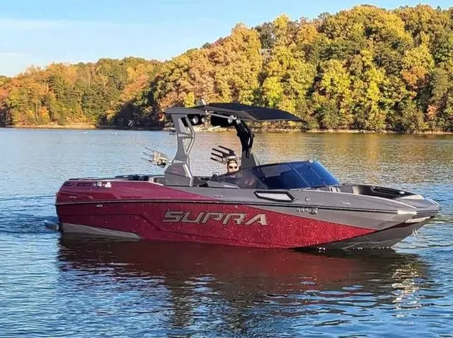 Slide: The Image of 2023 Supra SL550 boat on a calm lake in autumn. - 3