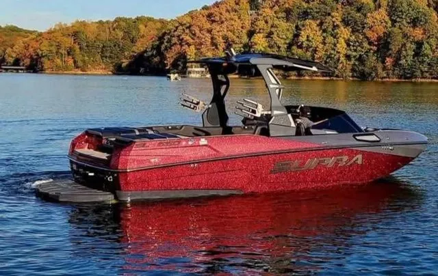 Slide: The Image of 2023 Supra SL550 boat on a serene lake in autumn. - 4