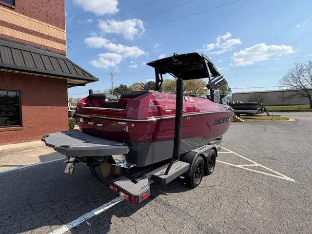 Slide: The Image of 2023 Supra SL550 boat parked outdoors on a trailer. - 6