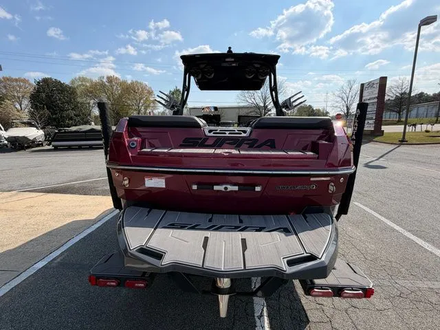 Slide: The Image of Rear view of a 2023 Supra SL550 boat in a parking lot. - 8