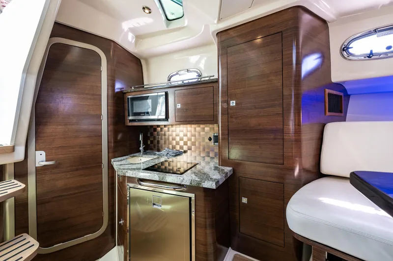 Slide: The Image of Luxurious interior of 2019 Boston Whaler 345 Conquest with modern kitchenette and wood finish. - 18