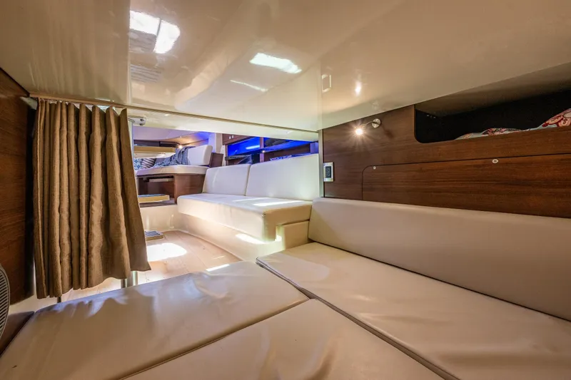 Slide: The Image of Interior of 2019 Boston Whaler 345 Conquest, featuring cozy seating and modern design. - 19