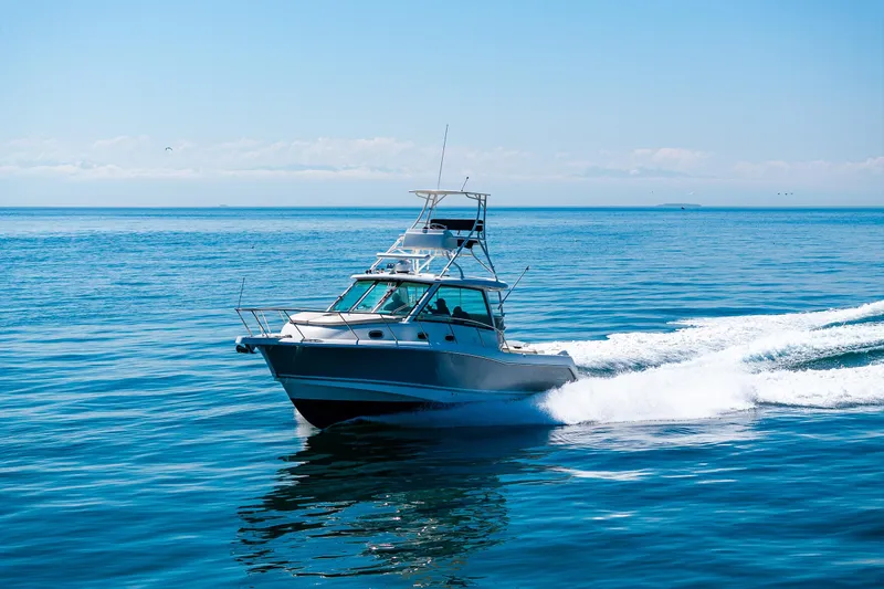 Slide: The Image of 2019 Boston Whaler 345 Conquest cruising on open blue ocean waters. - 3
