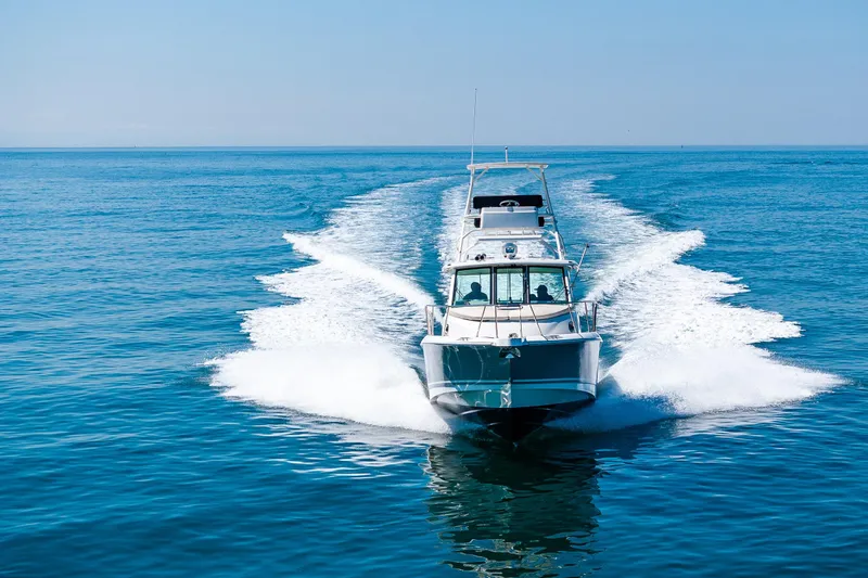 Slide: The Image of 2019 Boston Whaler 345 Conquest cruising on open blue water. - 4