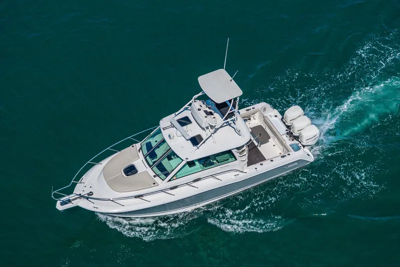 Slide: The Image of Aerial view of 2019 Boston Whaler 345 Conquest cruising on clear blue water. - 6