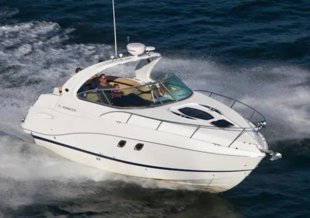 Slide: The Image of 2013 Rinker 310 Express Cruiser docked in marina, calm water, sunny day. - 2