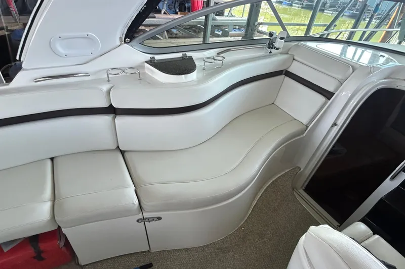 Slide: The Image of 2013 Rinker 310 Express Cruiser interior with white seating and cup holders. - 21