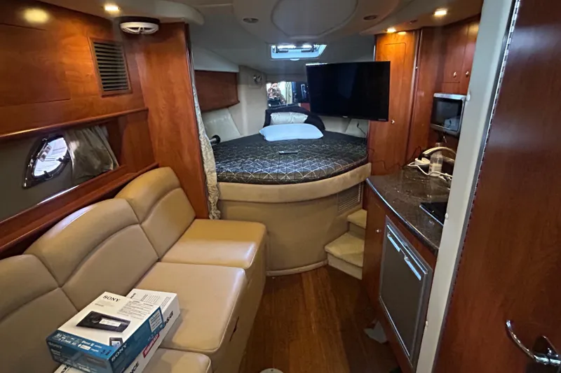 Slide: The Image of Luxurious interior of 2013 Rinker 310 Express Cruiser with cozy seating and modern amenities. - 23