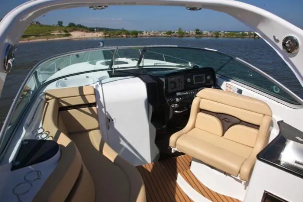 Slide: The Image of 2013 Rinker 310 Express Cruiser docked in a marina, rear view. - 5