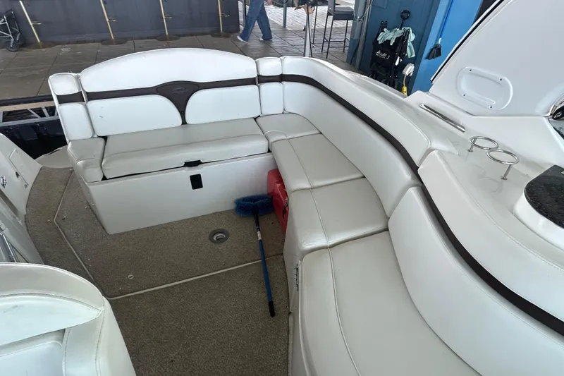Slide: The Image of 2013 Rinker 310 Express Cruiser interior with white seating and carpeted floor. - 54