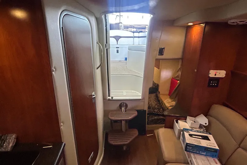 Slide: The Image of Interior of 2013 Rinker 310 Express Cruiser with wooden finishes and compact design. - 59