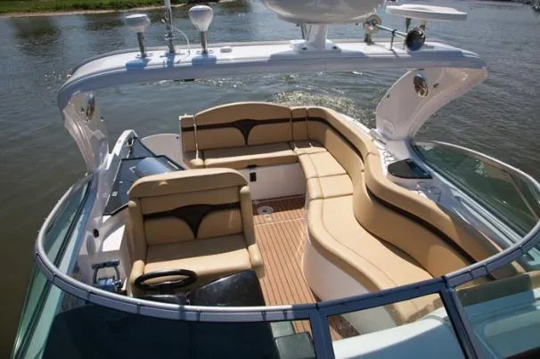 Slide: The Image of 2013 Rinker 310 Express Cruiser docked in a marina, side view. - 6