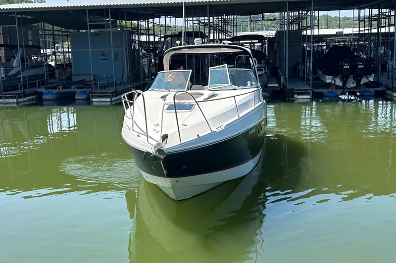 Slide: The Image of 2013 Rinker 310 Express Cruiser docked in marina, front view. - 63