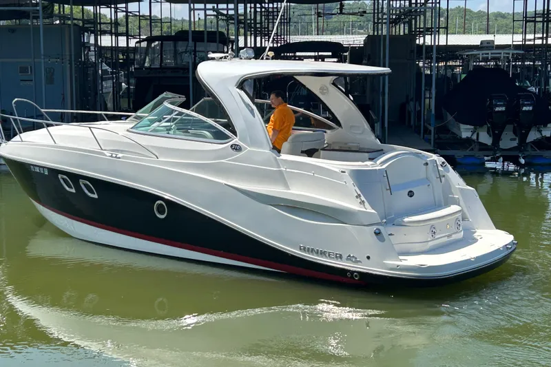 Slide: The Image of 2013 Rinker 310 Express Cruiser docked in marina, side view. - 76
