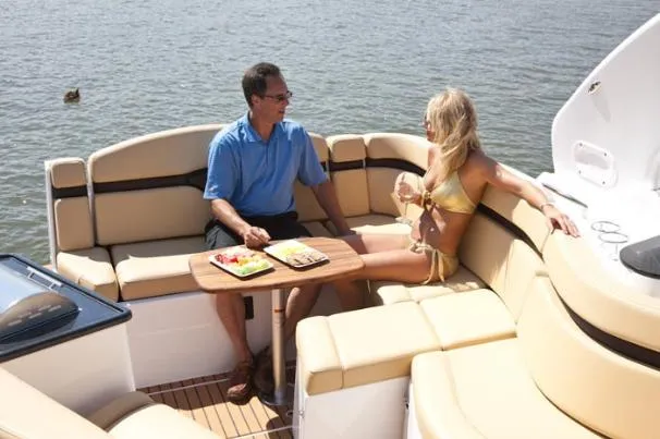 Slide: The Image of 2013 Rinker 310 Express Cruiser docked in a marina, side view. - 8
