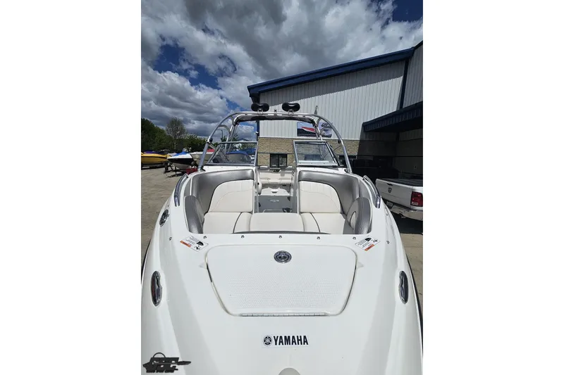 Slide: The Image of 2007 Yamaha Boats AR230 HO with white seating, docked under a cloudy sky. - 13