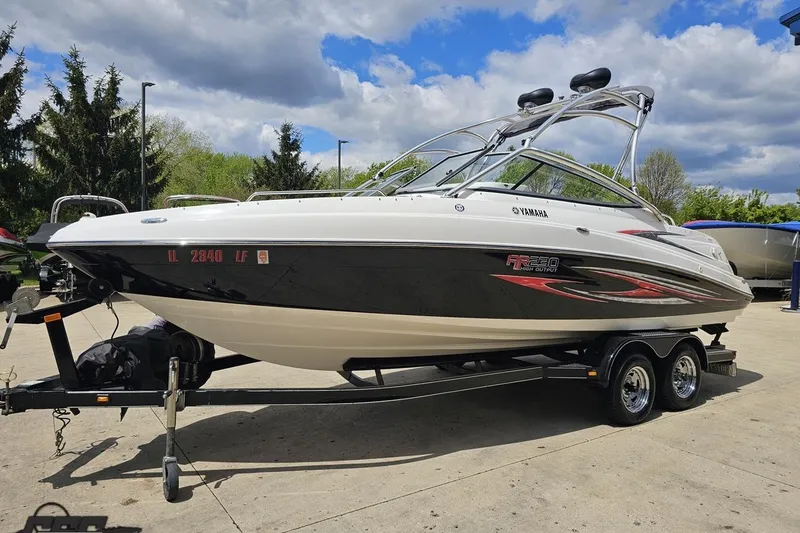 Slide: The Image of 2007 Yamaha Boats AR230 HO on trailer, sleek design, parked outdoors under cloudy sky. - 16