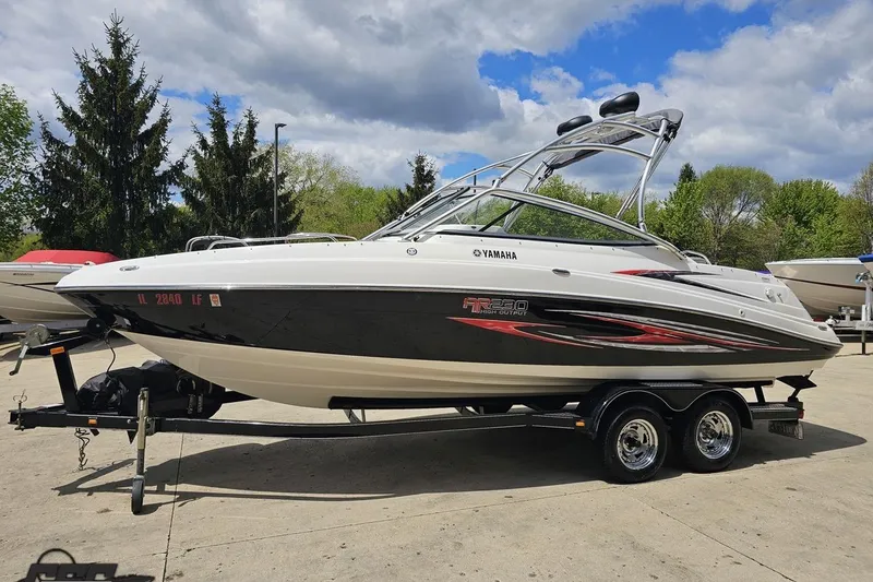 Slide: The Image of 2007 Yamaha Boats AR230 HO on trailer, parked outdoors under a partly cloudy sky. - 17