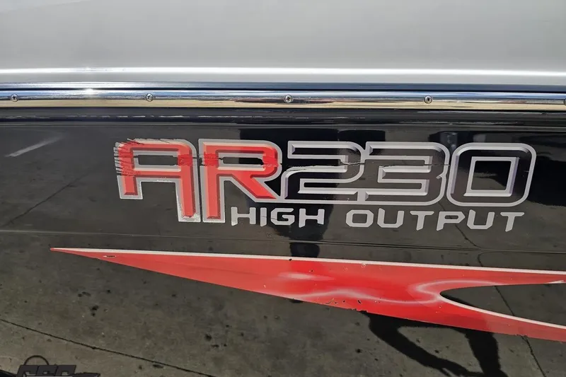 Slide: The Image of 2007 Yamaha Boats AR230 HO logo on sleek black surface with red accents. - 21