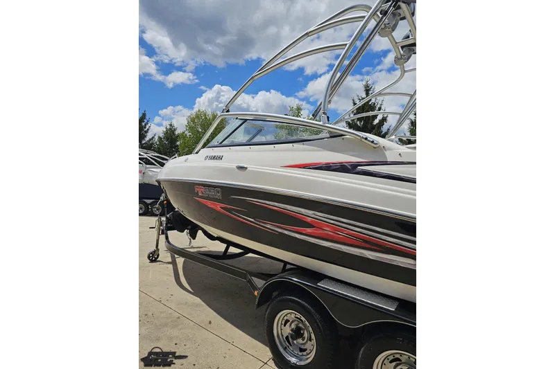 Slide: The Image of 2007 Yamaha AR230 HO boat on trailer under a partly cloudy sky. - 24