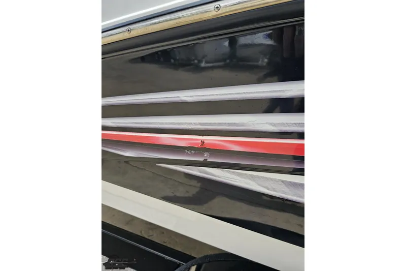 Slide: The Image of 2007 Yamaha AR230 HO boat with damaged hull graphics. - 32
