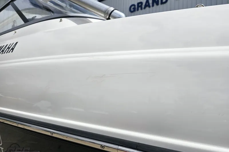 Slide: The Image of 2007 Yamaha Boats AR230 HO side view with visible scratches on the hull. - 36