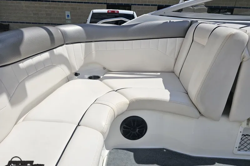 Slide: The Image of 2007 Yamaha Boats AR230 HO interior seating with white upholstery and cup holder. - 46