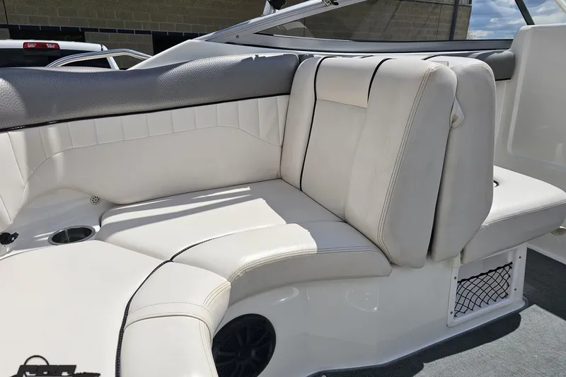 Slide: The Image of 2007 Yamaha Boats AR230 HO interior seating with white upholstery and cup holder. - 47