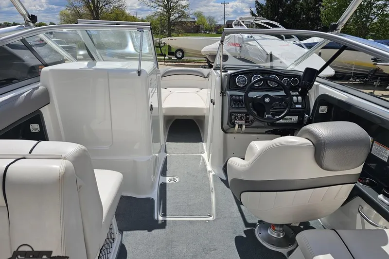 Slide: The Image of 2007 Yamaha Boats AR230 HO interior with steering wheel and seating, showcasing modern design. - 48