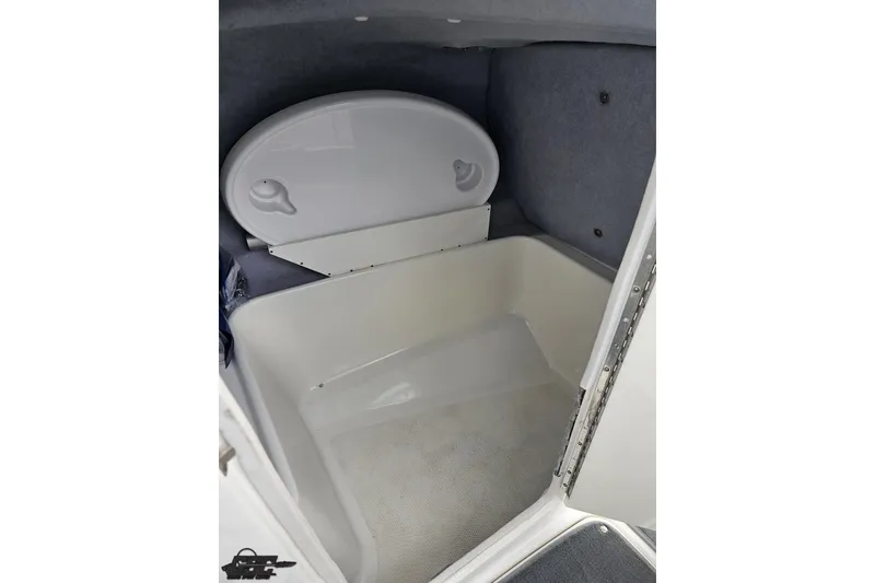 Slide: The Image of 2007 Yamaha Boats AR230 HO interior storage compartment with white lid and carpeted floor. - 53