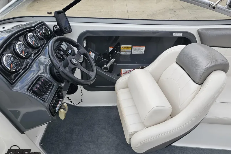 Slide: The Image of 2007 Yamaha Boats AR230 HO cockpit with steering wheel, gauges, and plush captain's chair. - 54