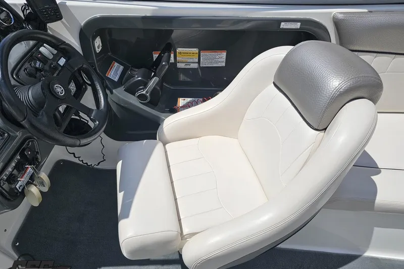 Slide: The Image of 2007 Yamaha Boats AR230 HO cockpit with steering wheel and comfortable seating. - 55