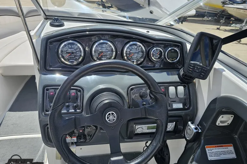 Slide: The Image of Dashboard of a 2007 Yamaha Boats AR230 HO, featuring gauges and controls. - 57