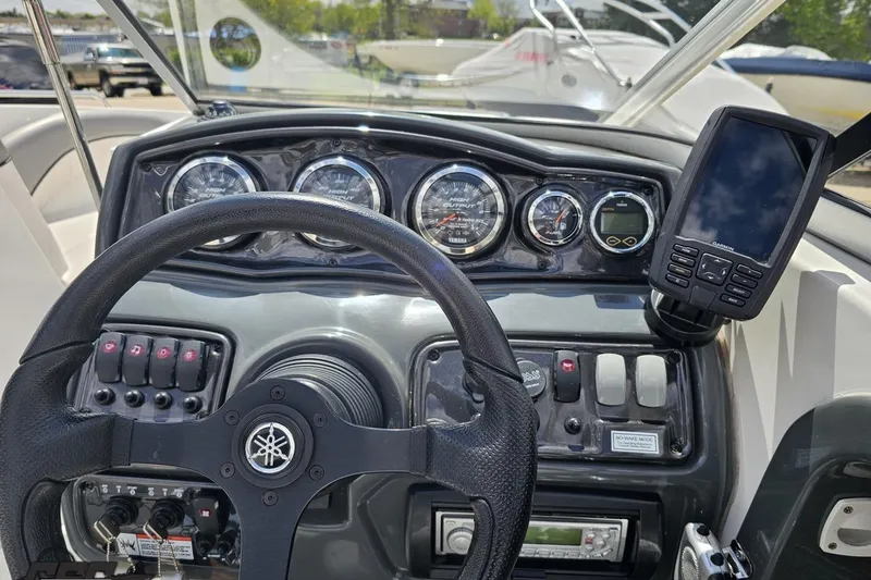 Slide: The Image of Steering console of a 2007 Yamaha Boats AR230 HO with gauges and navigation system. - 58